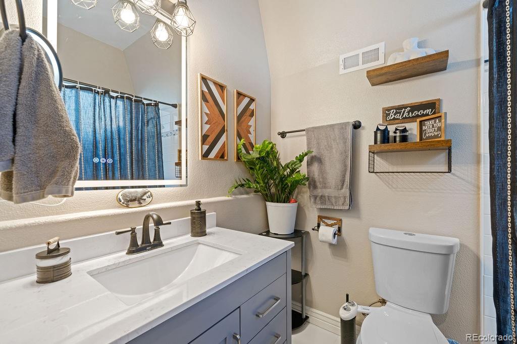 8450 Edison Road Yoder, CO 80864 - Photo 20 of 50 a bathroom with a sink a toilet and a mirror