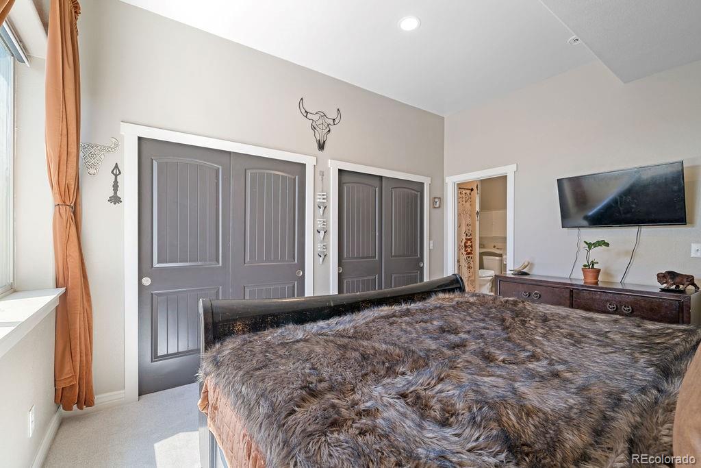 8450 Edison Road Yoder, CO 80864 - Photo 22 of 50 a bedroom with a bed and a flat screen tv