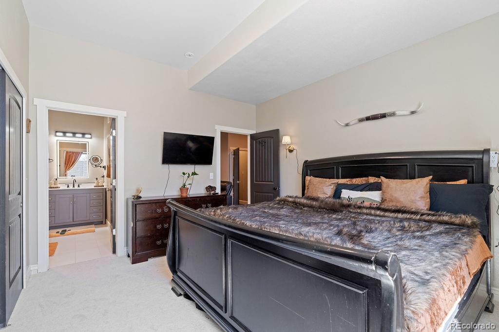 8450 Edison Road Yoder, CO 80864 - Photo 23 of 50 a bedroom with a bed and flat tv screen on the dresser
