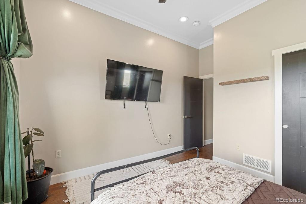 8450 Edison Road Yoder, CO 80864 - Photo 39 of 50 a bedroom with a bed and a flat screen tv