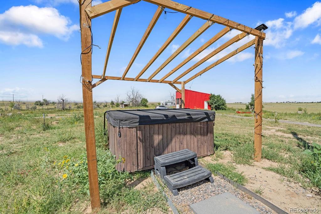 8450 Edison Road Yoder, CO 80864 - Photo 49 of 50 a view of a deck with a floor to ceiling window next to a yard