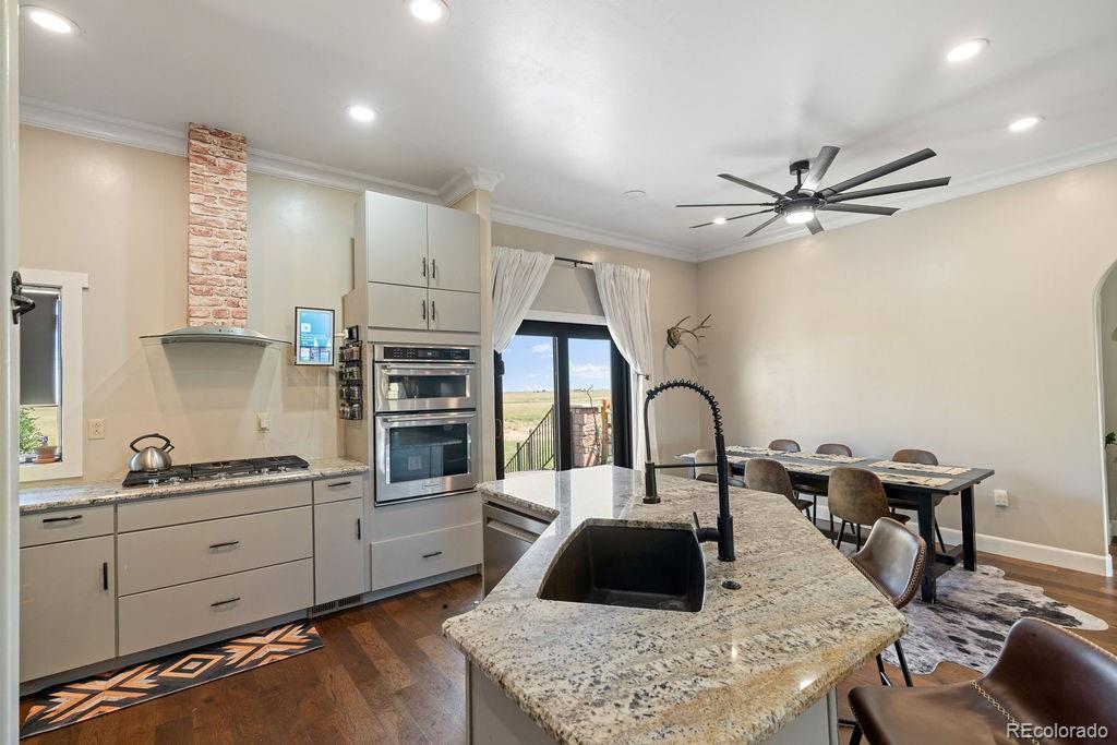 8450 Edison Road Yoder, CO 80864 - Photo 5 of 50 a kitchen with stainless steel appliances granite countertop a sink a stove and a refrigerator