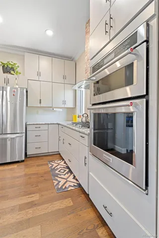 a kitchen with stainless steel appliances a stove microwave and cabinets