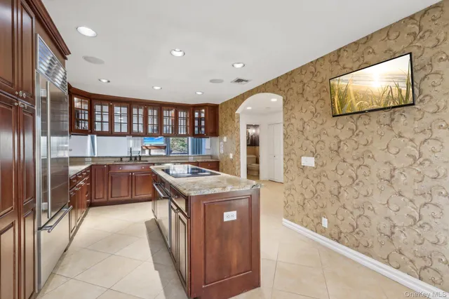 a kitchen with granite countertop a sink and a stove top oven
