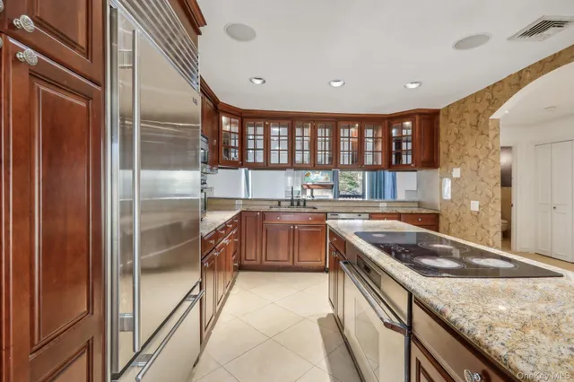a kitchen with stainless steel appliances granite countertop a sink and a stove