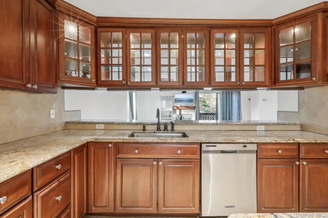 a kitchen with stainless steel appliances granite countertop a sink and cabinets