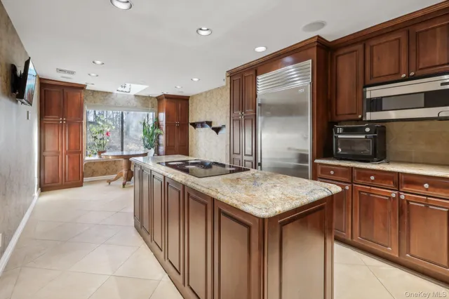 a kitchen with stainless steel appliances granite countertop a stove a sink dishwasher and a refrigerator