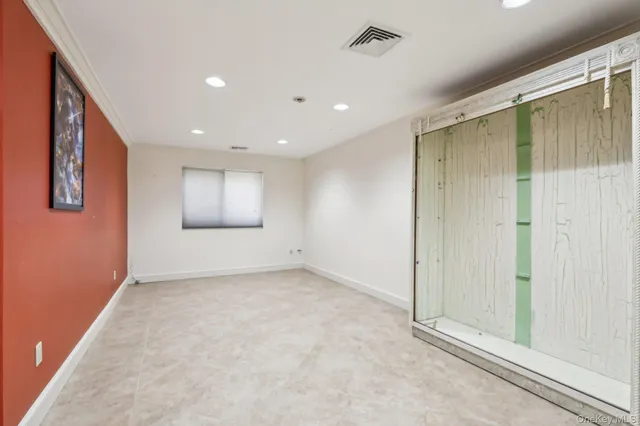 an empty room with windows and closet