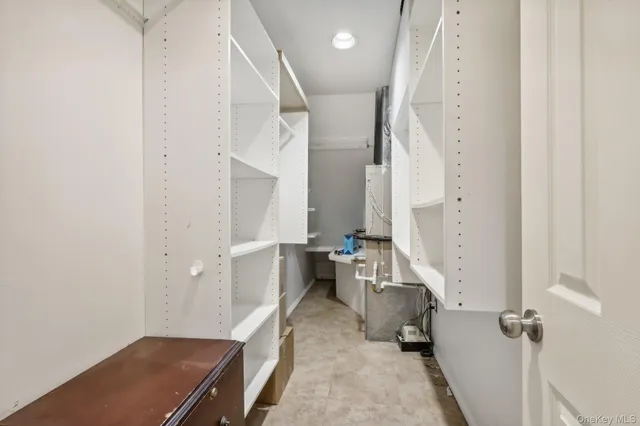 a room with a chair and white walls