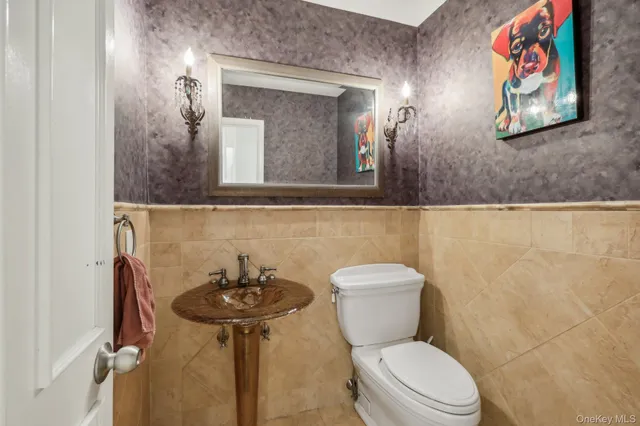 a bathroom with a toilet a sink and mirror