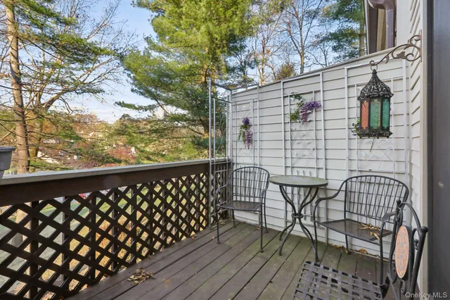 a view of a balcony with wooden chairs