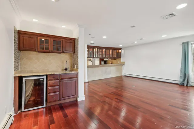 a kitchen with stainless steel appliances granite countertop a stove and a wooden floors