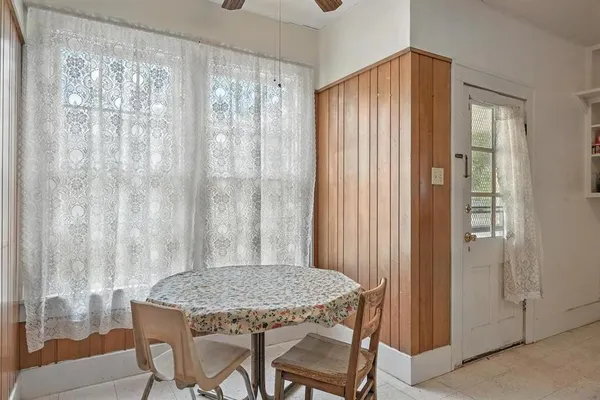 a view of a room with furniture and curtain