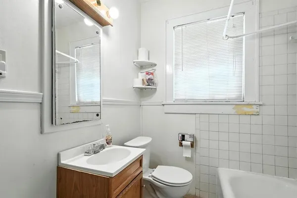 a bathroom with a sink mirror toilet and shower