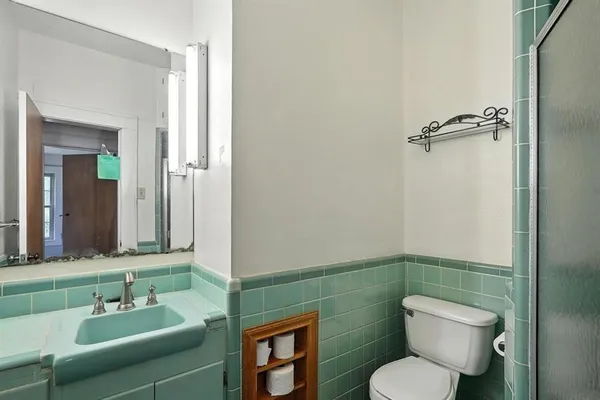 an empty room with a window and a ceiling fan