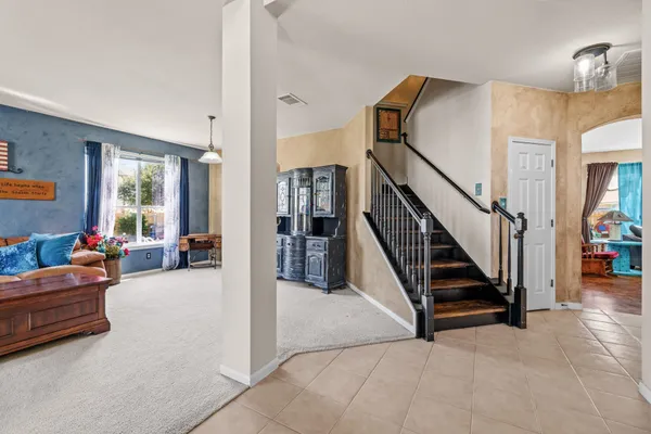 a view of living room with furniture and a refrigerator