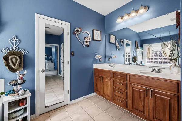 a spacious bathroom with a double vanity sink and a mirror