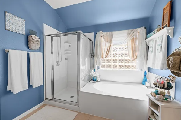 a bathroom with a bathtub and a shower