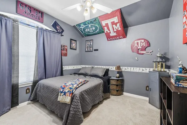 a bedroom with a bed and a window