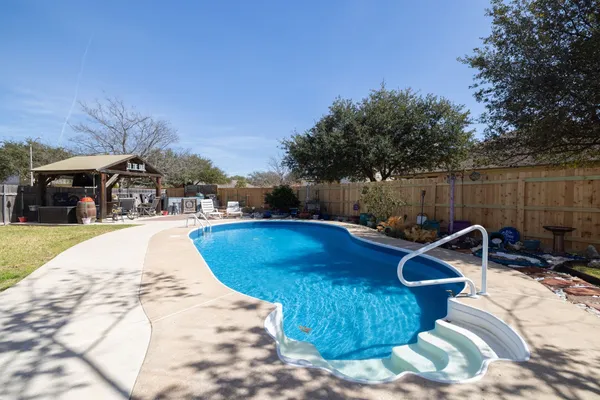 a view of a swimming pool with a patio