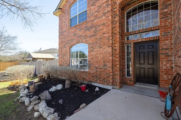 a view of a brick house with a yard