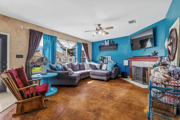 a living room with furniture a flat screen tv and a fireplace