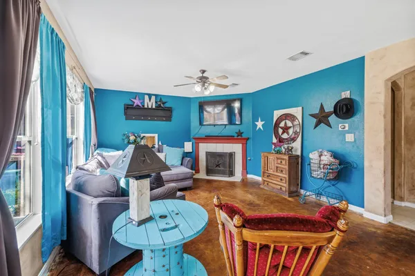 a living room with furniture a flat screen tv and a table