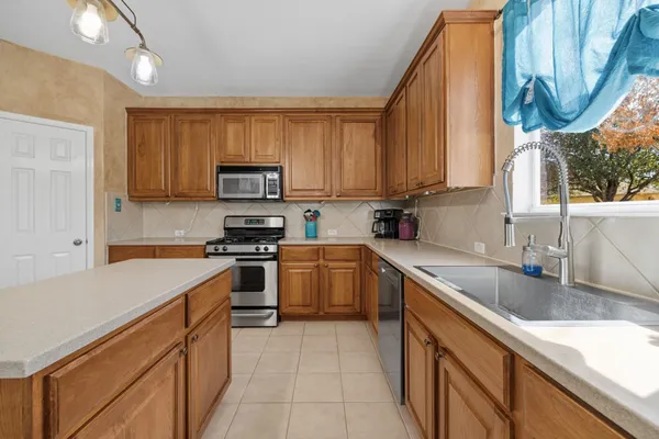 a kitchen that has a lot of cabinets in it