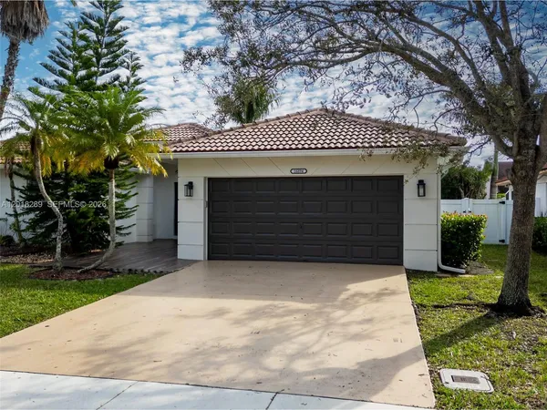 a front view of a house with a yard and garage