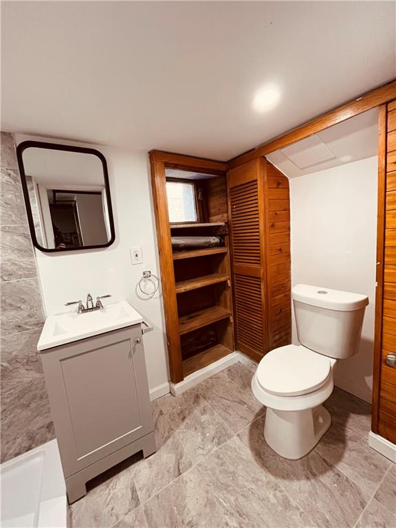 5144 Natrona Way Pittsburgh, PA 15201 - Photo 10 of 11 a bathroom with a toilet a sink and a mirror