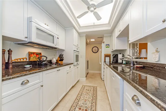 a kitchen with stainless steel appliances granite countertop a sink and cabinets