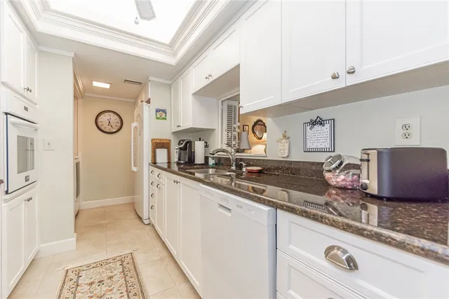 a large kitchen with granite countertop a sink and a stove