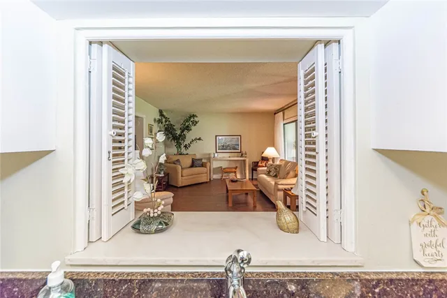 a view of a livingroom with furniture and a window