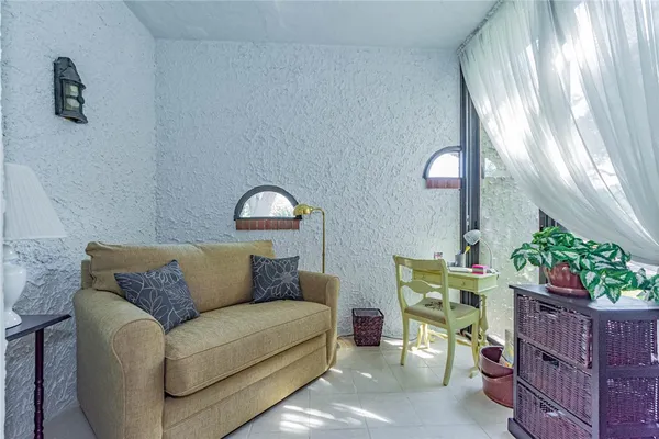 a living room with furniture flowerpot and a window