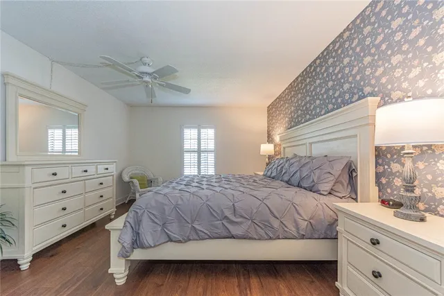 a bedroom with a large bed and a window