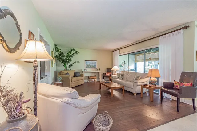 a living room with furniture a table and a large window