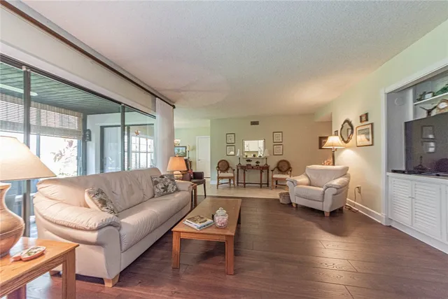 a living room with furniture or couch and a large window