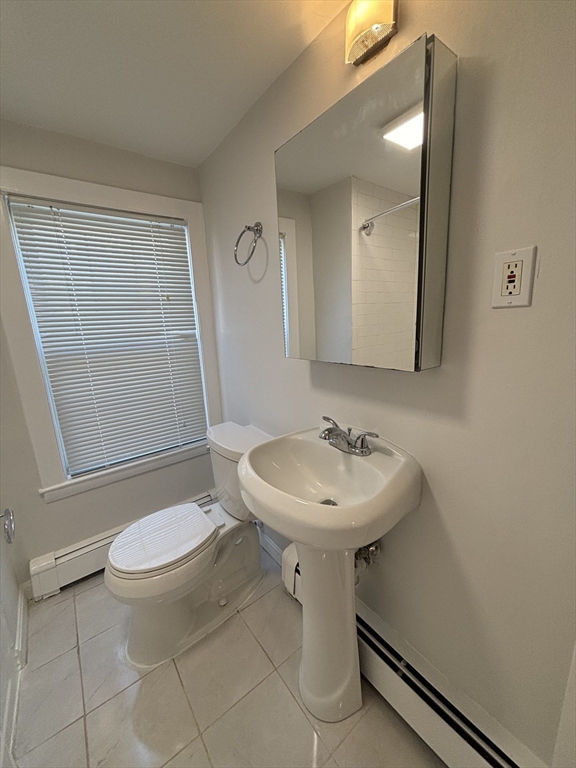 79 Pleasant Street, Unit 1 Stoneham, MA 02180 - Photo 4 of 7 a bathroom with a sink toilet and mirror