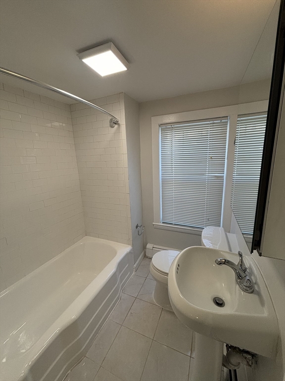 79 Pleasant Street, Unit 1 Stoneham, MA 02180 - Photo 5 of 7 a bathroom with a sink and a bathtub