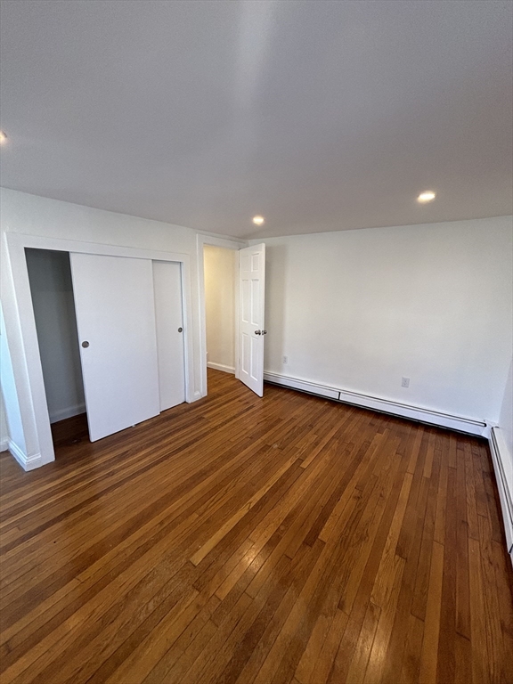 79 Pleasant Street, Unit 1 Stoneham, MA 02180 - Photo 6 of 7 a view of empty room with wooden floor