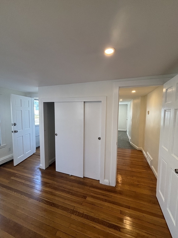 79 Pleasant Street, Unit 1 Stoneham, MA 02180 - Photo 7 of 7 a view of a hallway with wooden floor