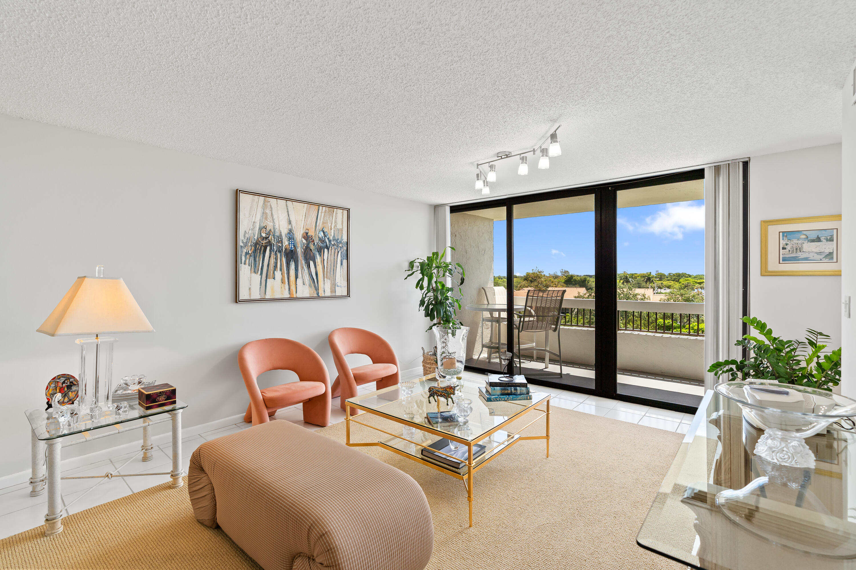 23200 Camino Del Mar, Unit 603 Boca Raton, FL 33433 - Photo 6 of 43 a living room with furniture a lamp and a large window