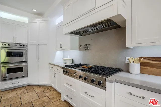 a kitchen with stainless steel appliances a stove a microwave and cabinets