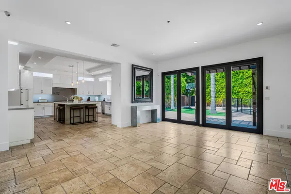 a view of a kitchen with furniture and large windows