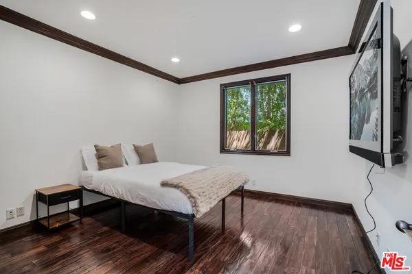 a living room with a bed furniture and a window