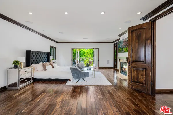 a living room with furniture windows and wooden floor
