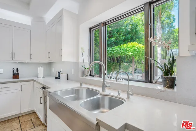 a kitchen with a sink and a large window