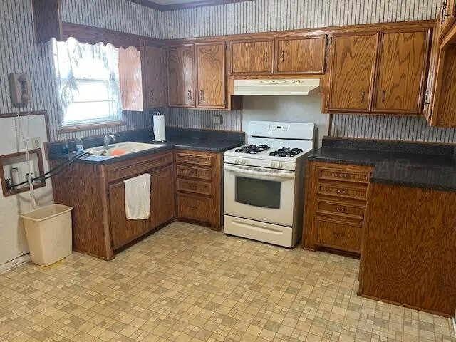 a kitchen with a stove and a sink