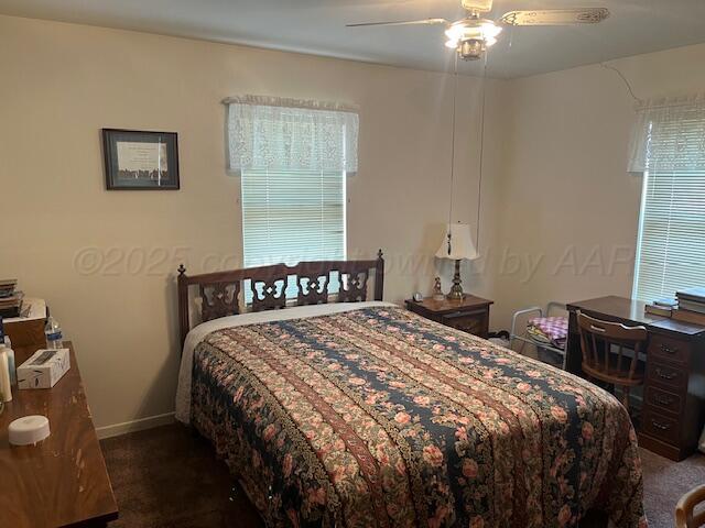 3811 Lakeview Road Hereford, TX 79045 - Photo 9 of 12 a bedroom with a bed and a chandelier