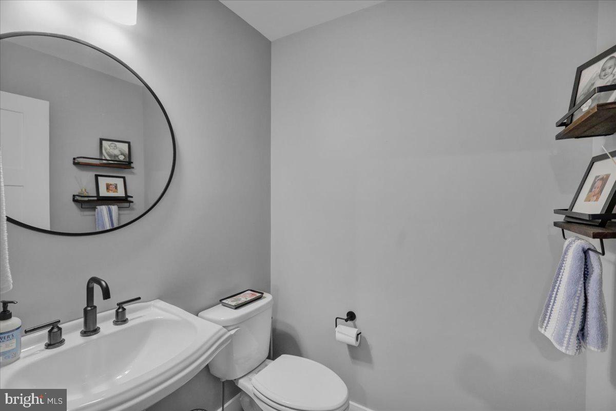1057 Ryebrook Road Reading, PA 19608 - Photo 19 of 49 a bathroom with a toilet sink and mirror